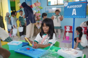 Potret siswa Playgroup-A yang terlihat serius bermain pasir